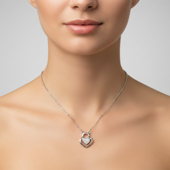Silver heart-shaped necklace on a model against a neutral background